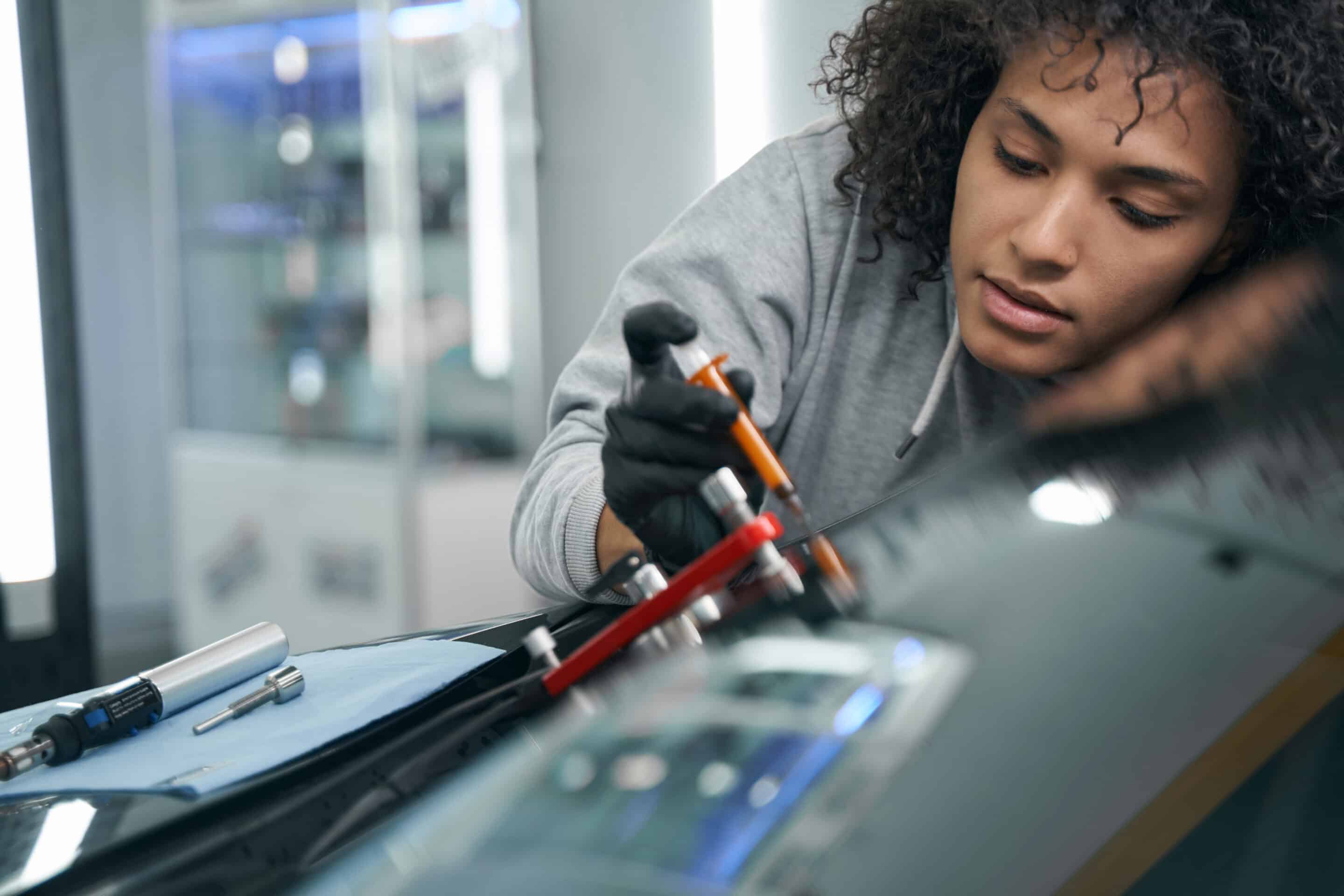 Concentrated skilled worker repairing damaged windshield on customer car concentrated skilled worker repairing damaged wind 2025 03 09 15 08 43 utc scaled